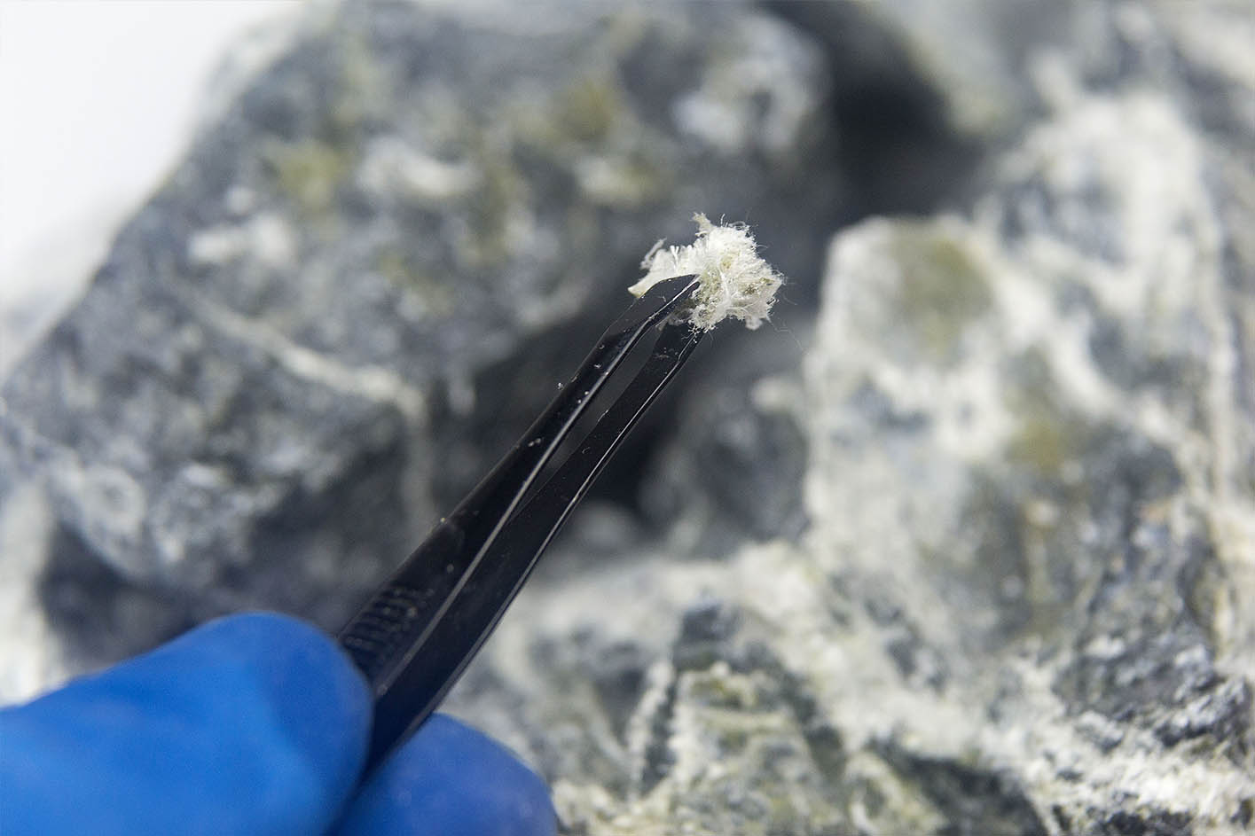 woman wearing mask and holding clipboard assessing worksite