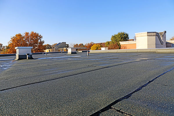 Building with newly renovated flat roof sealing